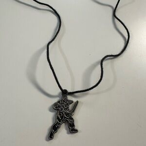 Y2K DISNEY PIRATES OF THE CARRIBEAN black cord charm necklace.